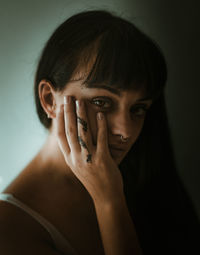 Close-up portrait of woman covering face