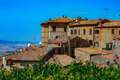 Old town by buildings against blue sky