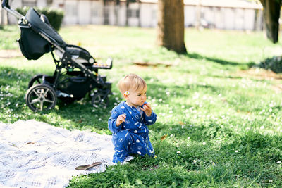 Boy sitting on field