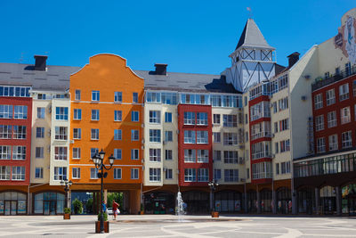 Residential buildings against clear blue sky