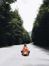 Woman sitting on road