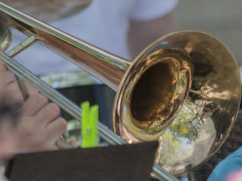 Cropped hands of man playing trumpet