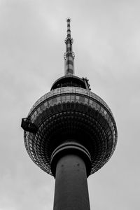 Low angle view of communications tower against sky