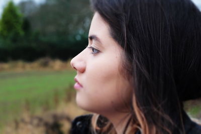 Close-up portrait of young woman looking away