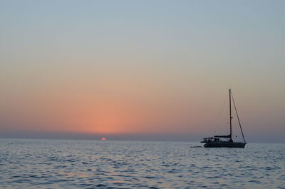 Scenic view of sea against clear sky during sunset