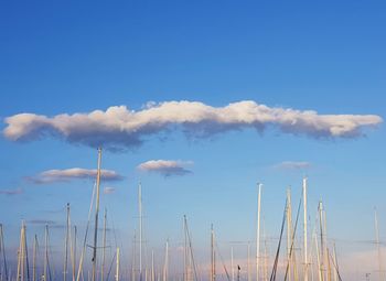 Low angle view of sailboats against blue sky