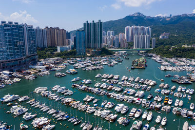 Aerial view of city by sea against sky