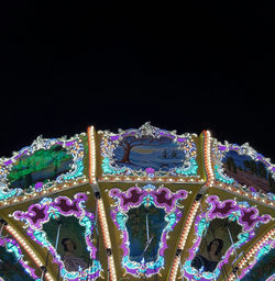 Low angle view of illuminated christmas tree against sky at night