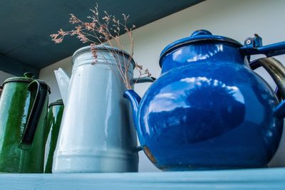 Low angle view of blue glass in container