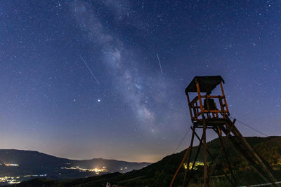 Low angle view of tower against sky at night