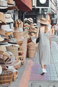 Rear view of woman in basket for sale