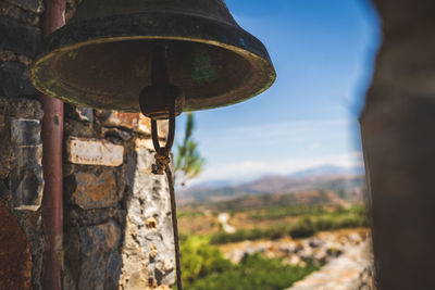 Close-up of old bell against wall