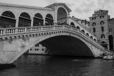 Arch bridge over river in city