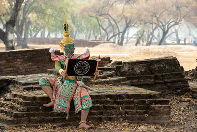 Full length of boy against wall at temple