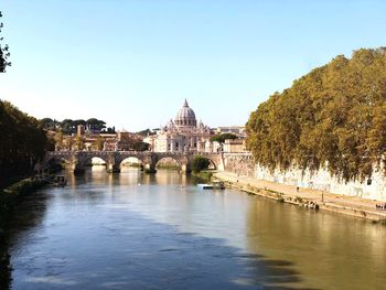 Bridge over river with buildings in background