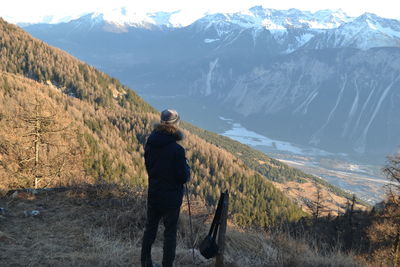 Rear view of woman standing on mountain