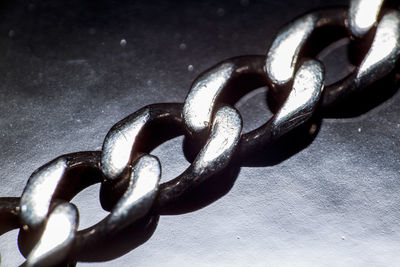 Close-up of metal chain on table