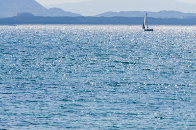 Scenic view of sea with a yacht against sky