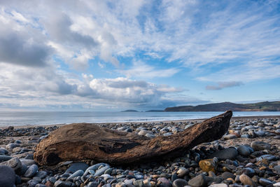 Rocks on beach against sky