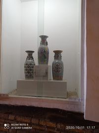 View of vase on shelf against wall