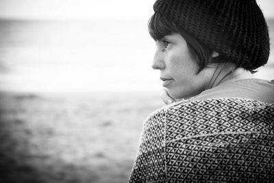 Close-up of woman sitting at beach