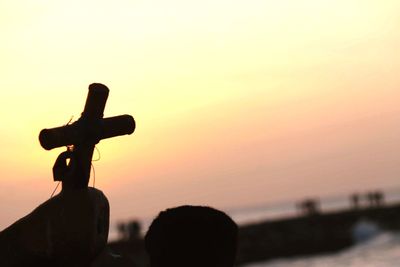 Close-up of silhouette person against sky during sunset