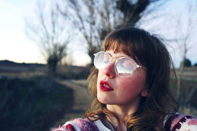 Close-up of young woman sitting on road