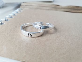 Close-up of wedding rings on table