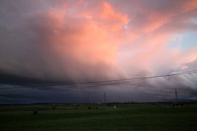 Scenic view of field against sky during sunset