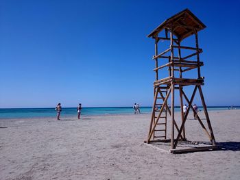 Lifeguard hut at beach against clear sky