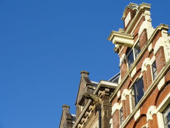 Low angle view of building against clear blue sky