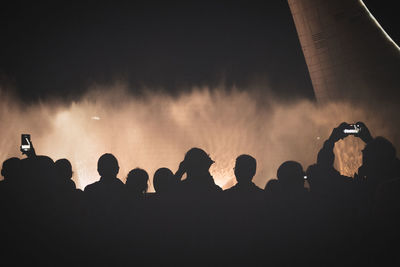 Silhouette people at night