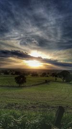 Scenic view of field against sky during sunset