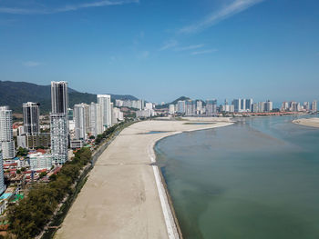 River amidst buildings against blue sky