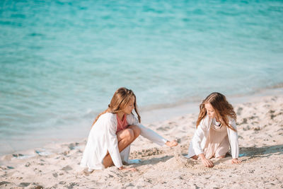 Rear view of women on beach