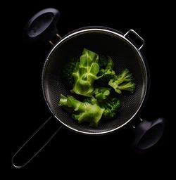 Directly above shot of salad in plate against black background