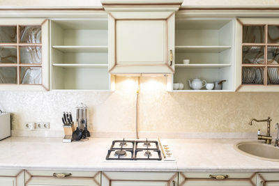 White kitchen set in the house with large dining room.