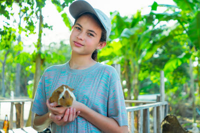 Friendship, girl and mammal, beautiful white girl holding guinea pig, cute relationship