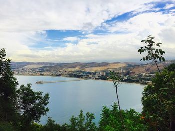 Scenic view of river against cloudy sky