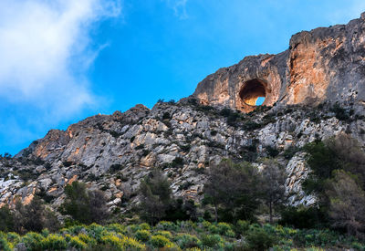 Low angle view of canelobre caves at busot against sky