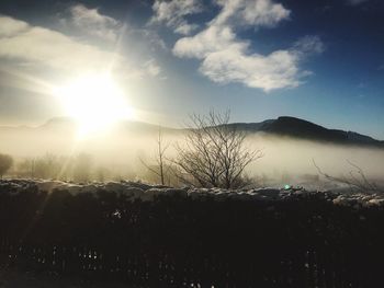 Scenic view of landscape against sky during winter