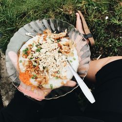 High angle view of woman holding fresh porridge