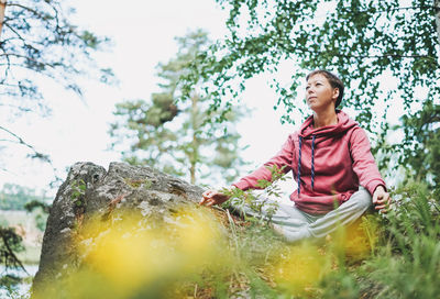 Young smiling woman practice yoga outdoors. new normal social distance. physical and mental health