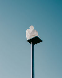 Low angle view of street light against blue sky