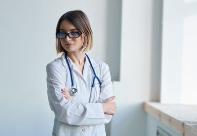 Doctor looking away while standing at hospital