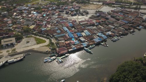 High angle view of buildings by river in city