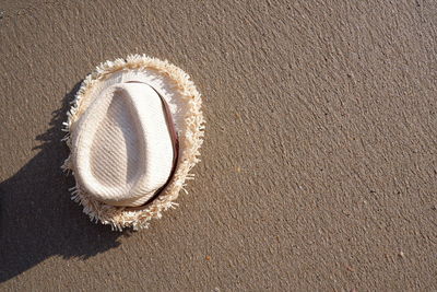 High angle view of hat on sand