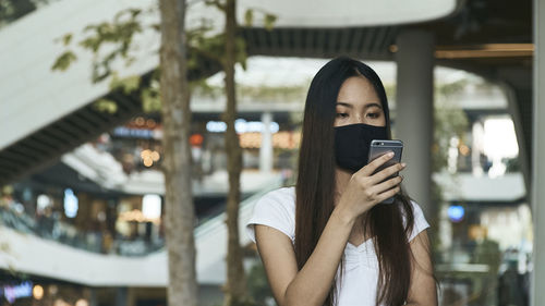 Portrait of young woman using mobile phone