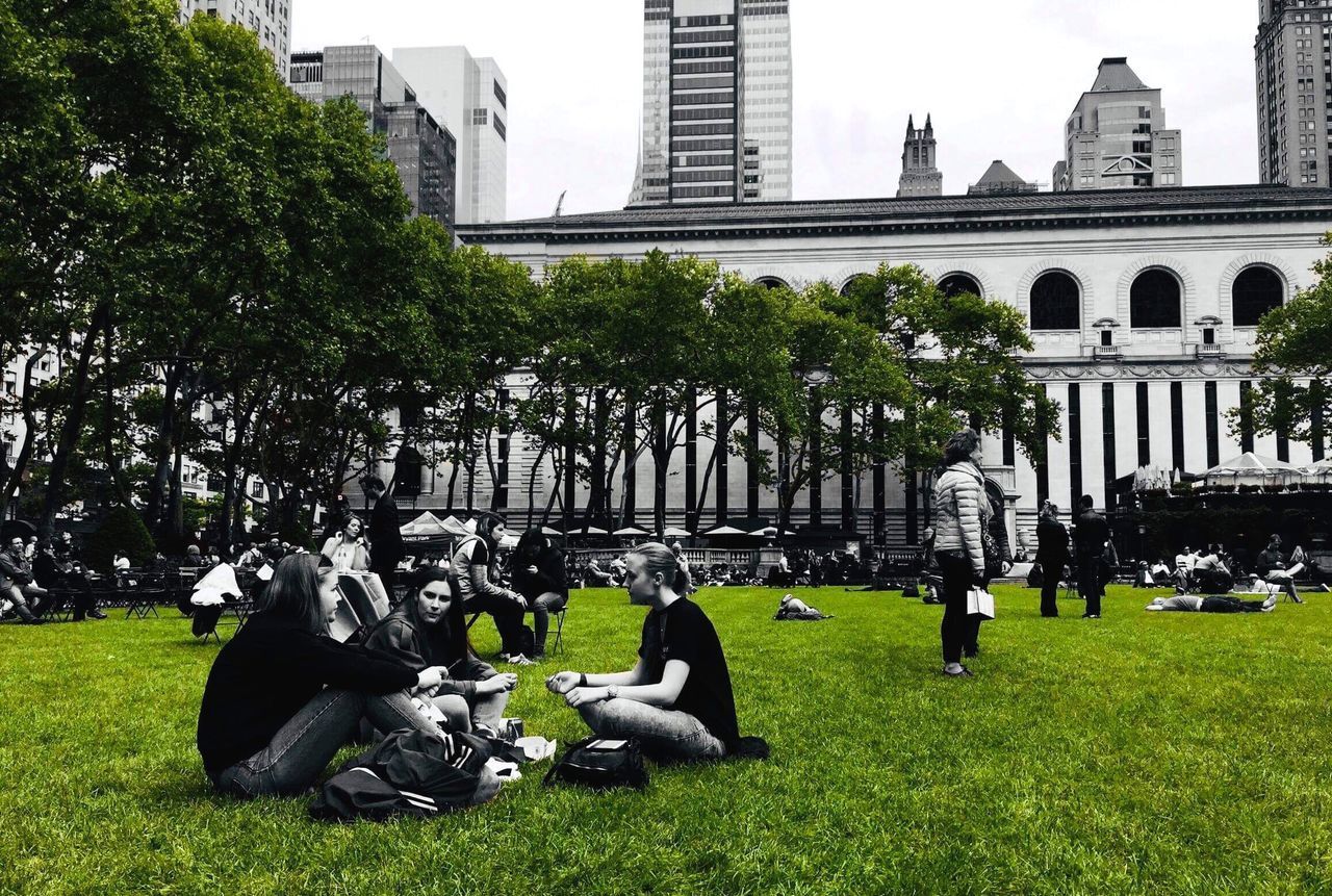 GROUP OF PEOPLE IN FRONT OF BUILDINGS