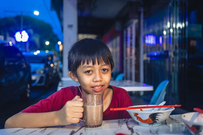 Portrait of boy enjoying his drink 